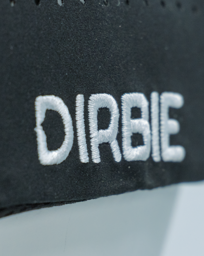 Close-up of a black fabric cap with white embroidered text reading &